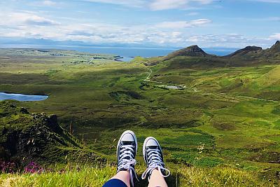 Sneakers in the foreground of a dramatic natural view